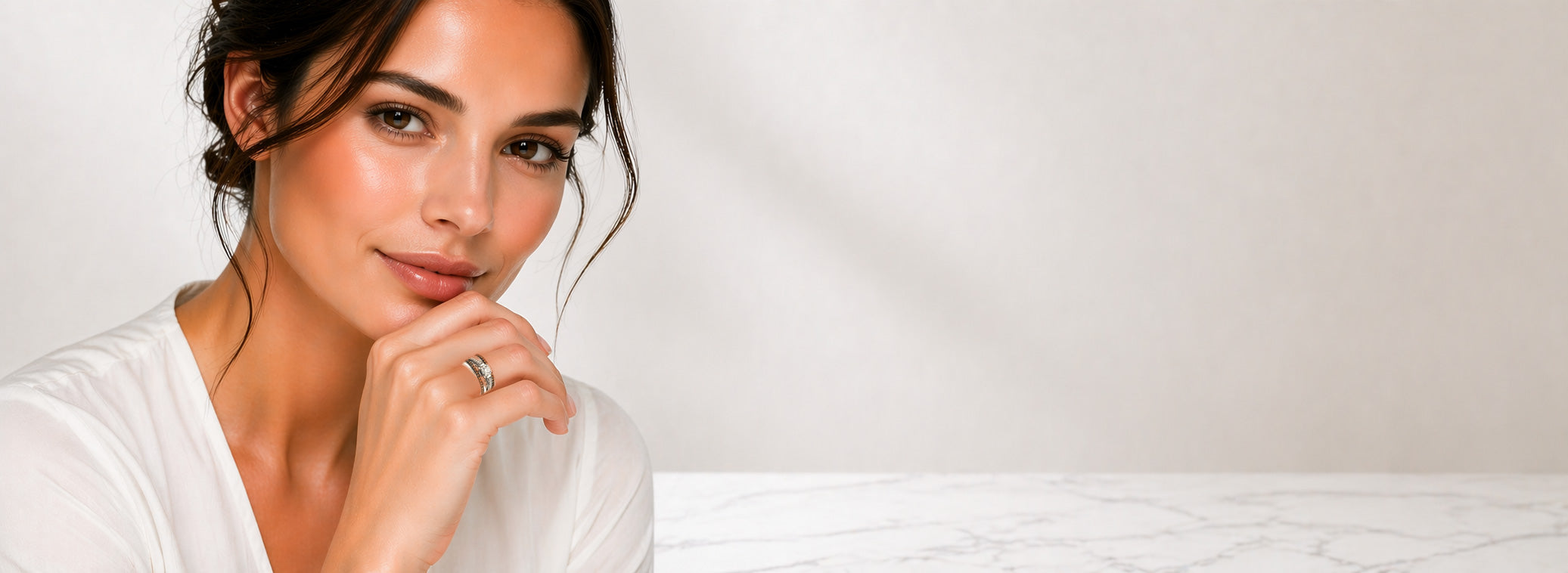 A woman wearing a Chocolate Diamond and Vanilla (White) Diamond Le Vian ring for the birthstone month of April.