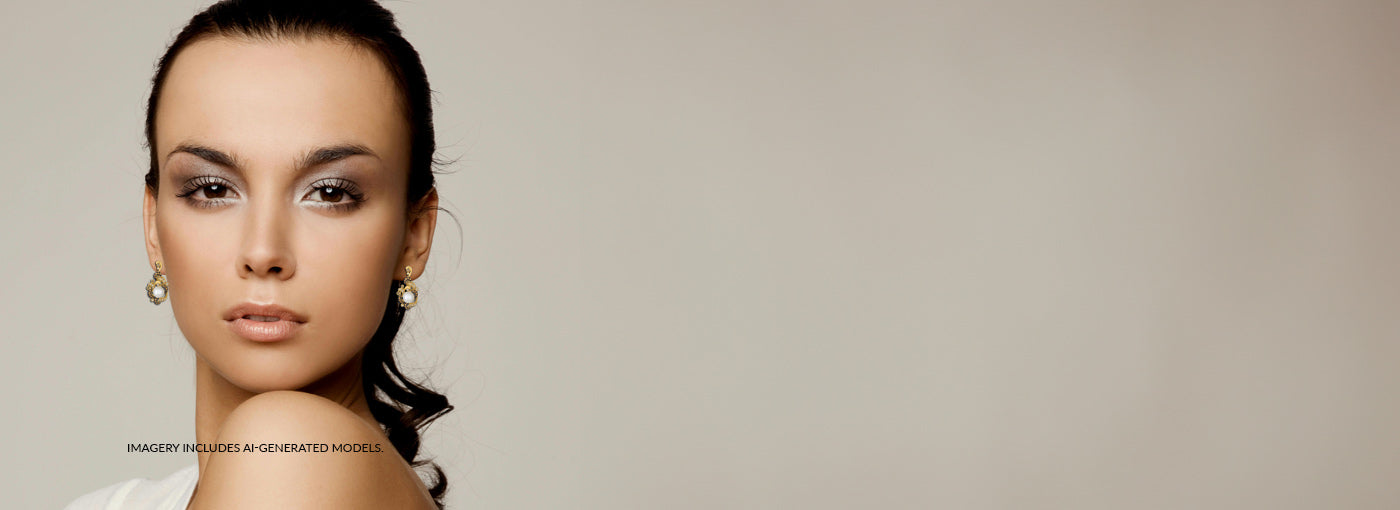 Woman with styled hair and earrings against a plain background